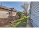Side yard with grass, a stone walkway, and a small amount of brush at 339 Delaware St, Denver, CO 80223