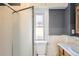 Updated bathroom features a glass shower, bright window, and convenient toilet at 339 Delaware St, Denver, CO 80223