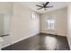Empty bedroom with a ceiling fan, hardwood flooring, and bright window to the yard outside at 339 Delaware St, Denver, CO 80223