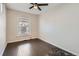 Bright bedroom with original hardwood flooring, fan lighting, and a window providing ample natural light at 339 Delaware St, Denver, CO 80223
