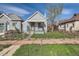 Charming home with a fenced yard and a welcoming front porch, complemented by blue sky at 339 Delaware St, Denver, CO 80223