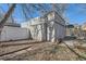 A detached garage with neutral-colored stucco, a door, and foliage shadow at 339 Delaware St, Denver, CO 80223