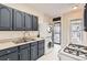 Cozy kitchen features updated gray cabinets and a convenient in-unit washer and dryer at 339 Delaware St, Denver, CO 80223