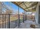 The porch has a metal awning and is fenced in with metal bars and steps at 339 Delaware St, Denver, CO 80223
