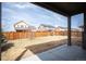 View of the backyard from the covered patio, enclosed by a wooden fence for privacy at 25403 E 2Nd Ave, Aurora, CO 80018