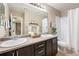 Bathroom featuring double sinks, modern fixtures, and plenty of counter space at 25403 E 2Nd Ave, Aurora, CO 80018