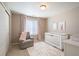 A calm Bedroom, featuring a crib, cozy chair and soft textures for serene atmosphere at 25403 E 2Nd Ave, Aurora, CO 80018