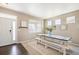 Bright dining area with a wooden table, bench seating, neutral decor, and lots of natural light at 25403 E 2Nd Ave, Aurora, CO 80018