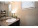 Cozy half bathroom with single vanity, neutral colors, and updated fixtures at 25403 E 2Nd Ave, Aurora, CO 80018