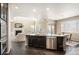 Open concept kitchen flowing into the living area with a fireplace and dining area at 25403 E 2Nd Ave, Aurora, CO 80018