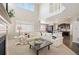 Elegant living room with fireplace, seamless flow into kitchen, and a soaring ceiling at 25403 E 2Nd Ave, Aurora, CO 80018