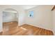 Bedroom featuring hardwood floors, an arched doorway, and a large window at 3293 S Florence Ct, Denver, CO 80231