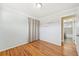 Neutral bedroom featuring hardwood floors, light gray walls, and direct bathroom access at 3293 S Florence Ct, Denver, CO 80231