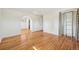 Hardwood bedroom featuring an arched doorway, closet space, and neutral paint at 3293 S Florence Ct, Denver, CO 80231