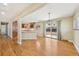 Bright dining area features hardwood floors, view to backyard, and opens to the updated kitchen at 3293 S Florence Ct, Denver, CO 80231