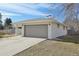 Ranch-style home with a two-car garage, long driveway and manicured lawn in a suburban neighborhood at 3293 S Florence Ct, Denver, CO 80231