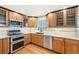 Kitchen features stainless steel appliances, gas range, and ample cabinet storage at 3293 S Florence Ct, Denver, CO 80231