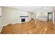 Spacious living room with hardwood floors, a white brick fireplace, and a staircase at 3293 S Florence Ct, Denver, CO 80231