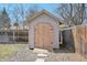 Wooden shed nestled in the backyard, providing ample storage for tools and equipment, great for organization at 3293 S Florence Ct, Denver, CO 80231