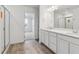 Bathroom with dual sink vanity, quartz countertop, and glass-enclosed shower at 19120 E 96Th Pl, Commerce City, CO 80022