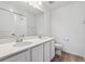 Bright bathroom featuring a double sink vanity with a large mirror and modern fixtures at 19120 E 96Th Pl, Commerce City, CO 80022