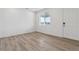 Bright bedroom with light wood flooring, a large window, and white door at 19120 E 96Th Pl, Commerce City, CO 80022
