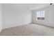 Bright bedroom with a large window and neutral carpeting at 19120 E 96Th Pl, Commerce City, CO 80022