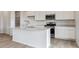 Bright kitchen featuring white cabinets, stainless steel appliances, and a center island at 19120 E 96Th Pl, Commerce City, CO 80022