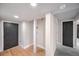 Finished basement featuring light wood flooring, neutral walls, white trim and black doors at 2380 Jasmine St, Denver, CO 80207