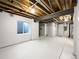Spacious unfinished basement with window and exposed ceiling, ready to be transformed at 6108 Kochia Ct # 104, Erie, CO 80516