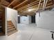 Large unfinished basement with staircase access, ready for customization and expansion at 6108 Kochia Ct # 104, Erie, CO 80516