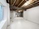 Unfinished basement with painted floor and exposed ceiling is ready for customization at 6108 Kochia Ct # 104, Erie, CO 80516