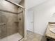Tiled shower stall with glass doors, plus granite countertop at 6108 Kochia Ct # 104, Erie, CO 80516
