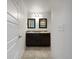 Bathroom featuring double sinks, granite counters, and modern lighting at 6108 Kochia Ct # 104, Erie, CO 80516