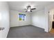 Bright bedroom featuring a ceiling fan, plush carpet, and sun-filled window at 6108 Kochia Ct # 104, Erie, CO 80516