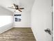 Light and airy bedroom showcasing wood floors and a modern ceiling fan at 6108 Kochia Ct # 104, Erie, CO 80516