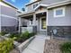 Inviting home featuring a cozy front porch, stone accents, and well-maintained landscaping at 6108 Kochia Ct # 104, Erie, CO 80516