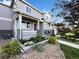 Charming home with covered porch, stone accents, and landscaped front yard at 6108 Kochia Ct # 104, Erie, CO 80516