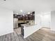 Well-lit kitchen boasting dark cabinets, stainless steel appliances, and laminate flooring at 6108 Kochia Ct # 104, Erie, CO 80516