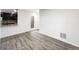 Open-concept living space showcasing durable wood flooring and bright, neutral wall paint at 6108 Kochia Ct # 104, Erie, CO 80516