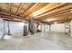 Unfinished basement with exposed ceiling, concrete floor, and white wall lining, offering potential for customization at 23201 E Orchard Pl, Aurora, CO 80015