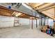 Unfinished basement featuring open joists and a concrete floor, offering space for storage or future renovation at 23201 E Orchard Pl, Aurora, CO 80015
