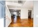 Inviting entryway featuring hardwood floors, a staircase, and views into the dining and kitchen areas at 23201 E Orchard Pl, Aurora, CO 80015