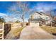 Two-story home featuring an attached garage and driveway, complemented by a well-kept lawn at 23201 E Orchard Pl, Aurora, CO 80015