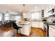 Bright kitchen featuring white cabinets, granite countertops, stainless steel appliances, and an island at 23201 E Orchard Pl, Aurora, CO 80015