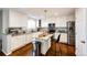 Bright kitchen featuring white cabinets, granite countertops, stainless steel appliances, and a kitchen island at 23201 E Orchard Pl, Aurora, CO 80015