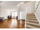 Bright living room featuring hardwood floors, a large window, and a staircase at 23201 E Orchard Pl, Aurora, CO 80015