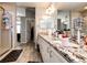 Well-lit primary bath with granite countertops, wood-look flooring, and separate shower offers practical luxury at 23201 E Orchard Pl, Aurora, CO 80015