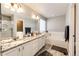 Primary bathroom boasts double sinks with granite counters, a separate tub, and a walk-in shower for convenience at 23201 E Orchard Pl, Aurora, CO 80015