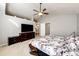 Bright main bedroom with a large TV, access to the bathroom, neutral carpet and color scheme offers a calming retreat at 23201 E Orchard Pl, Aurora, CO 80015
